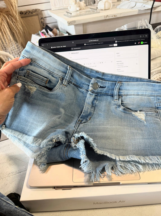 light blue ripped blank nye shorts size 4
